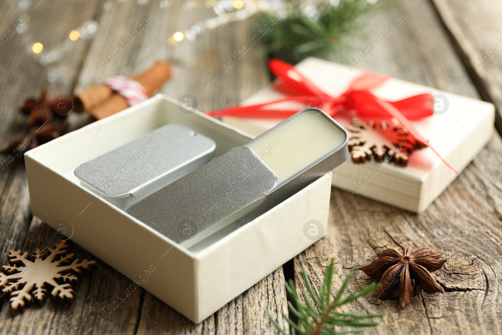 Photo of Natural solid perfume and Christmas decor on wooden table, closeup