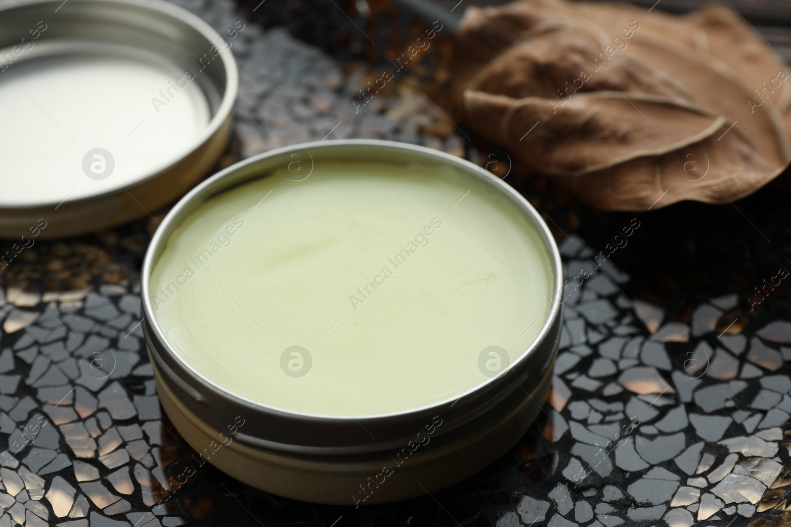 Photo of Natural solid perfume in container on surface, closeup