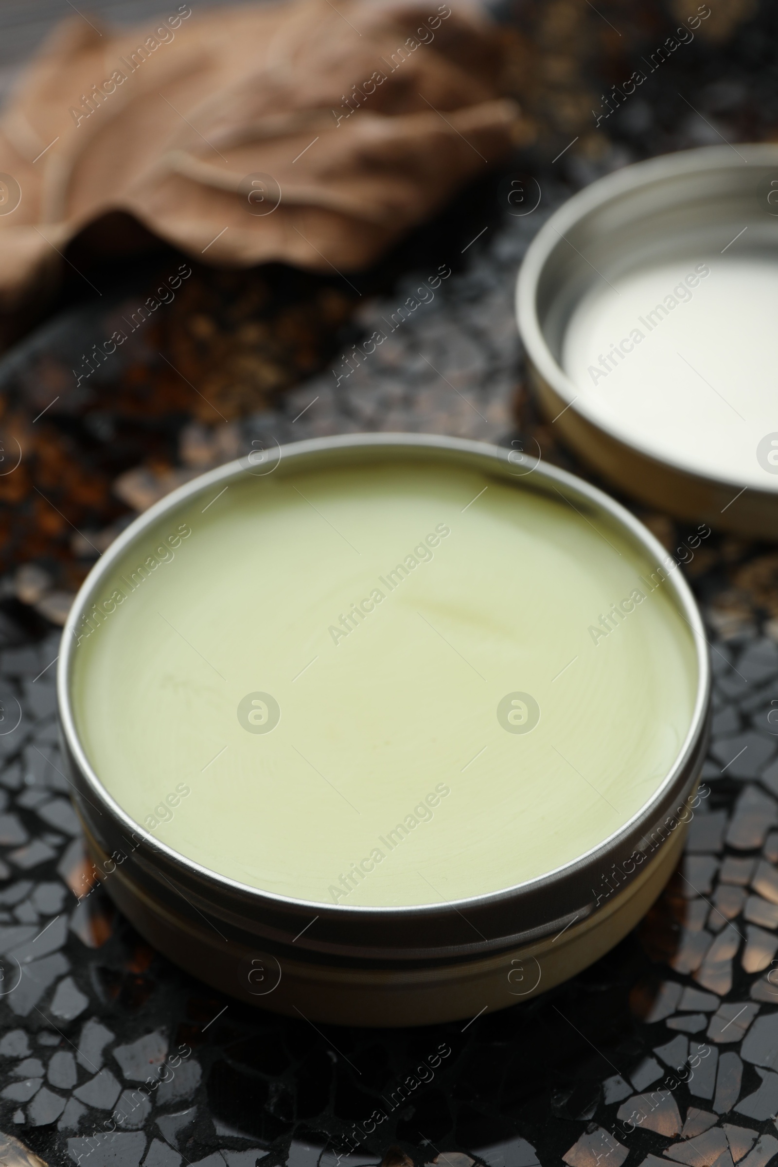 Photo of Natural solid perfume in container on surface, closeup