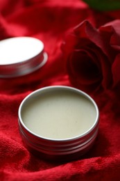 Photo of Natural solid perfume on red fabric, closeup