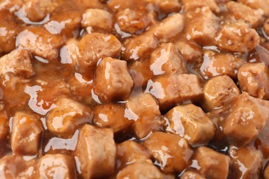 Photo of Pieces of wet pet food as background, closeup