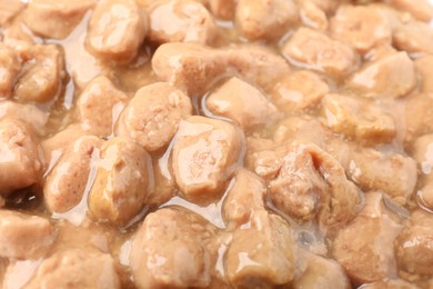 Photo of Pieces of wet pet food as background, closeup