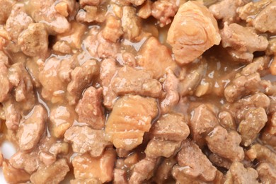 Pieces of wet pet food as background, top view