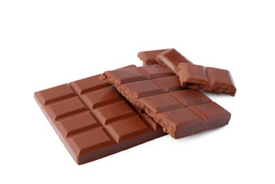 Photo of Pieces of delicious milk chocolate isolated on white