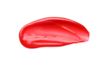 Photo of Red lip gloss isolated on white, top view. Sample of cosmetic product