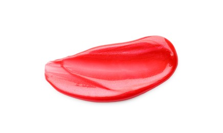 Photo of Red lip gloss isolated on white, top view. Sample of cosmetic product