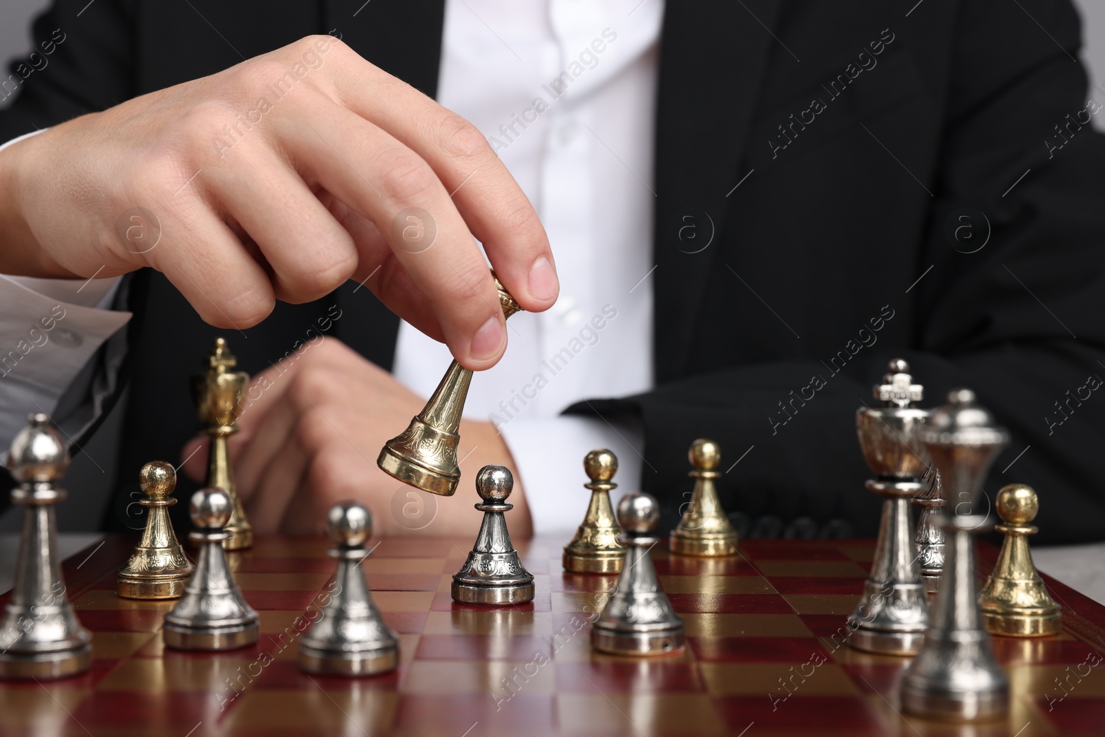 Photo of Businessman playing chess on chessboard, closeup. Competition concept