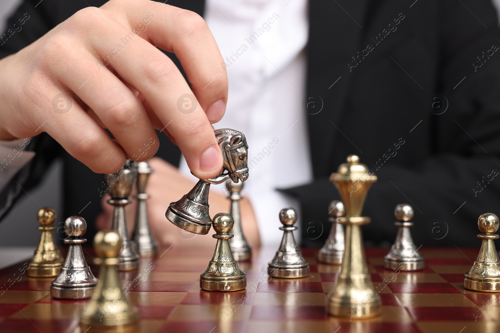 Photo of Businessman playing chess on chessboard, closeup. Competition concept