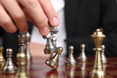 Photo of Businessman playing chess on chessboard, closeup. Competition concept