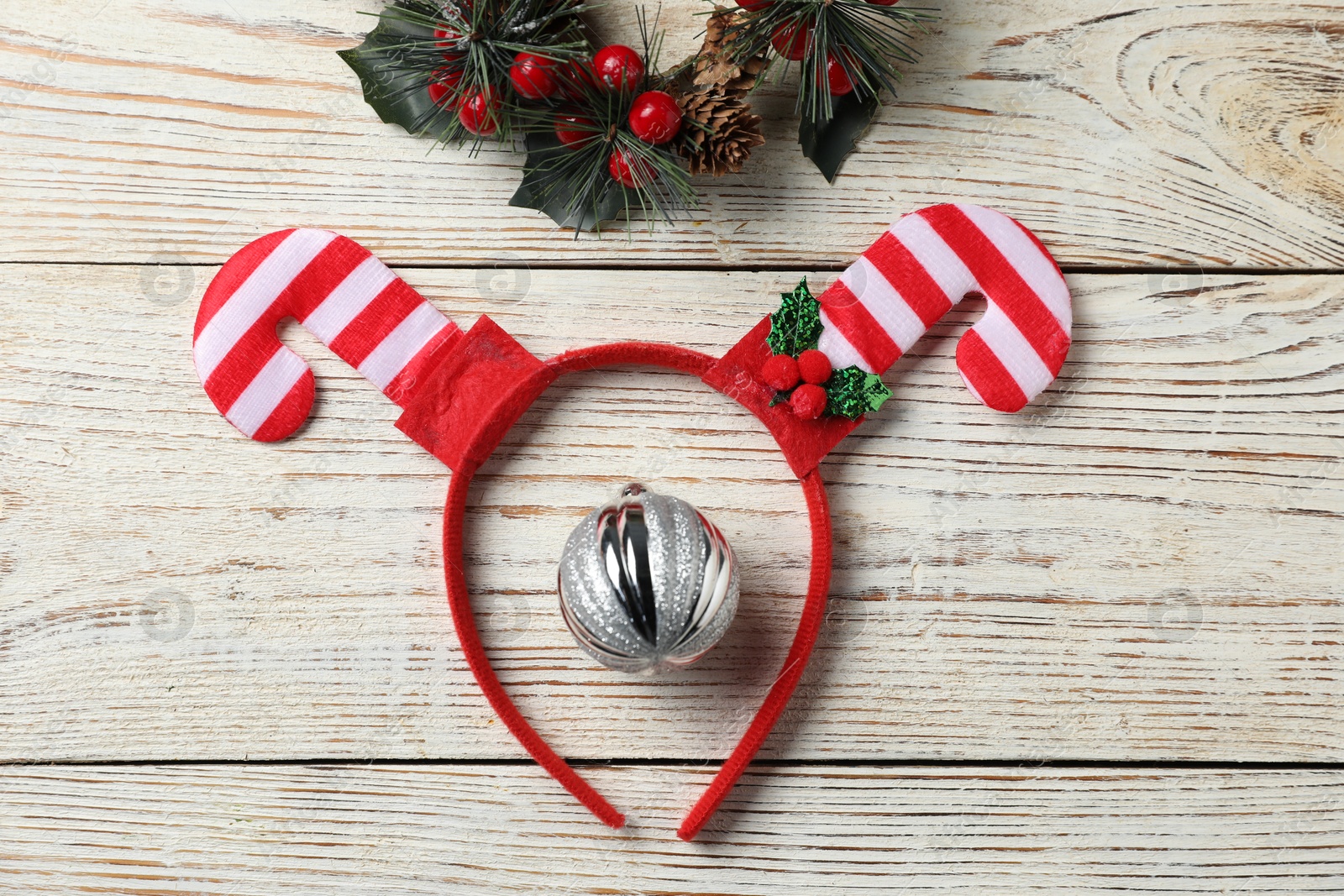 Photo of Stylish party headband and Christmas decor on white wooden background, flat lay