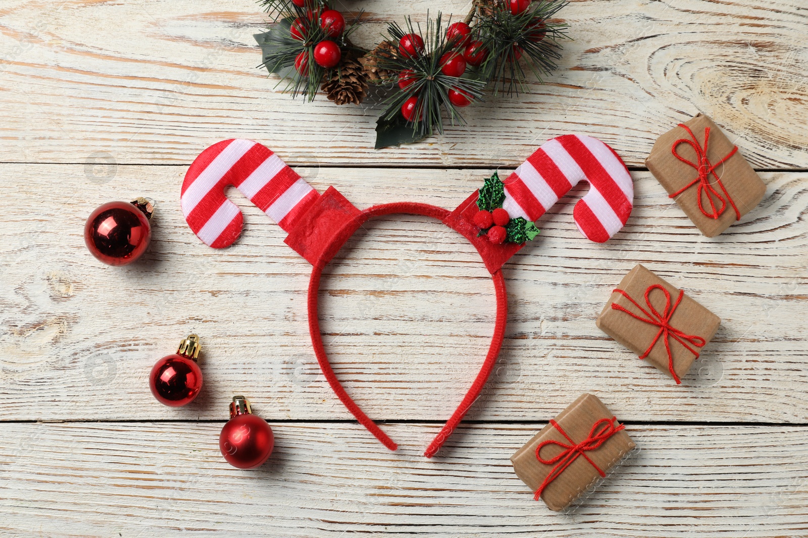 Photo of Stylish party headband and Christmas decor on white wooden background, flat lay