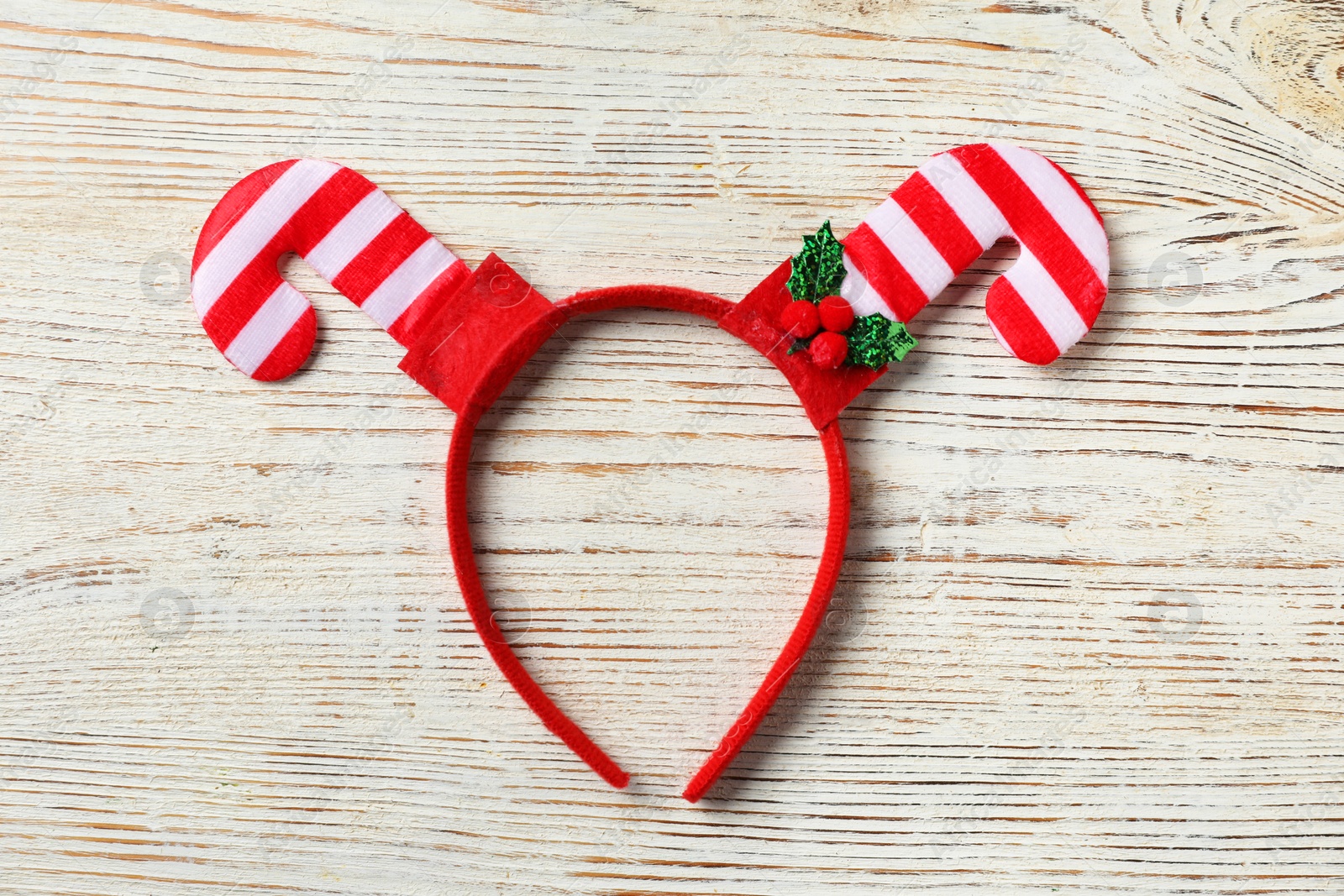 Photo of Stylish party headband on white wooden background, top view. Christmas accessory