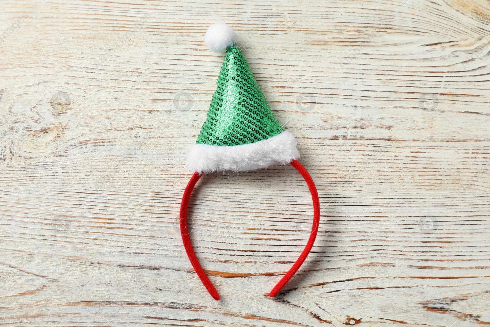 Photo of Stylish party headband on white wooden background, top view. Christmas accessory