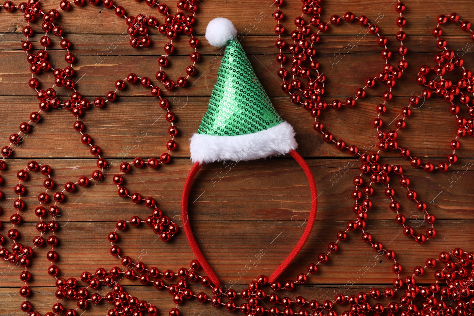 Photo of Stylish party headband and Christmas decor on wooden background, flat lay