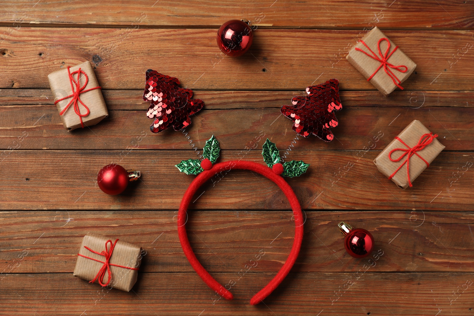 Photo of Stylish party headband and Christmas decor on wooden background, flat lay