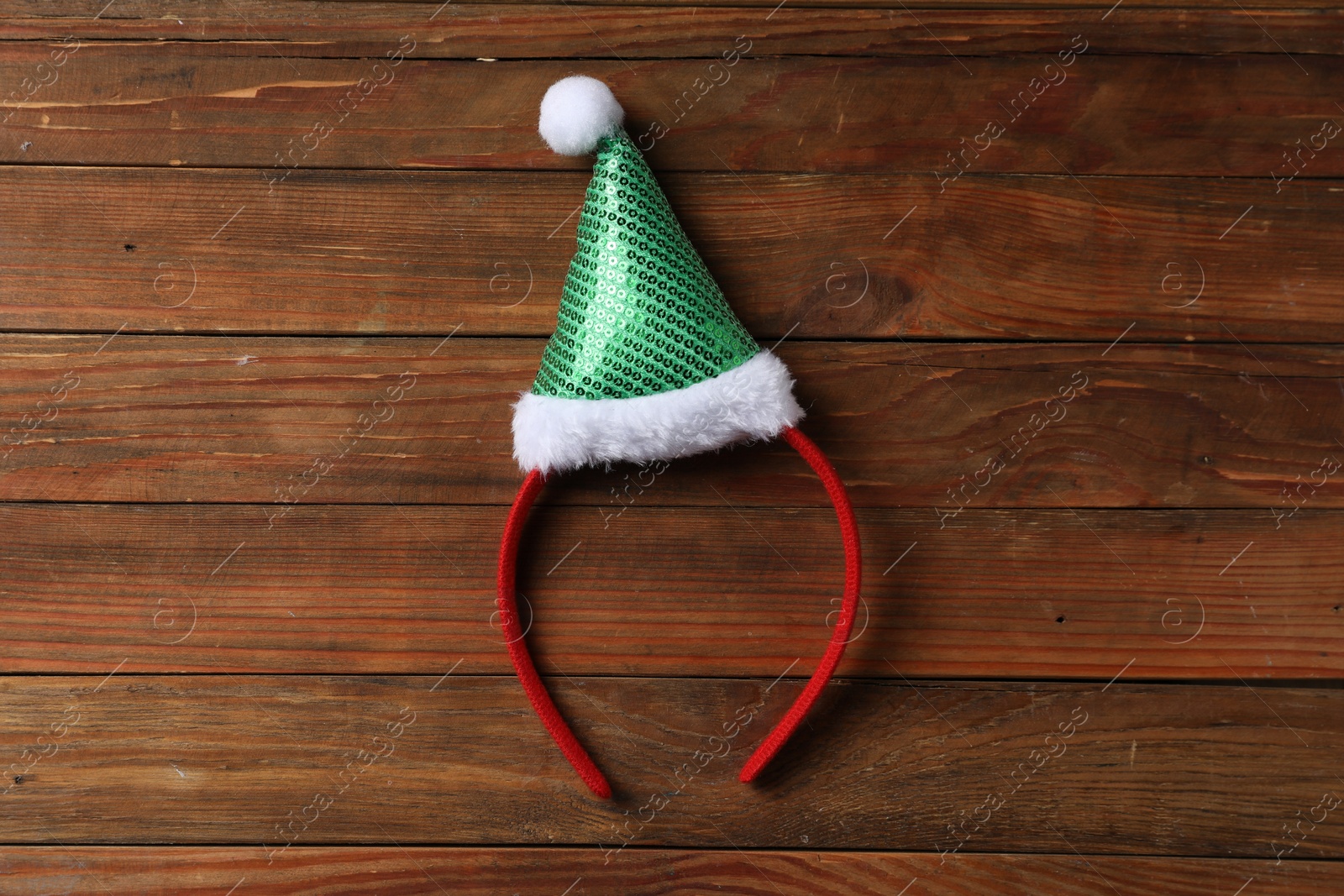 Photo of Stylish party headband on wooden background, top view. Christmas accessory