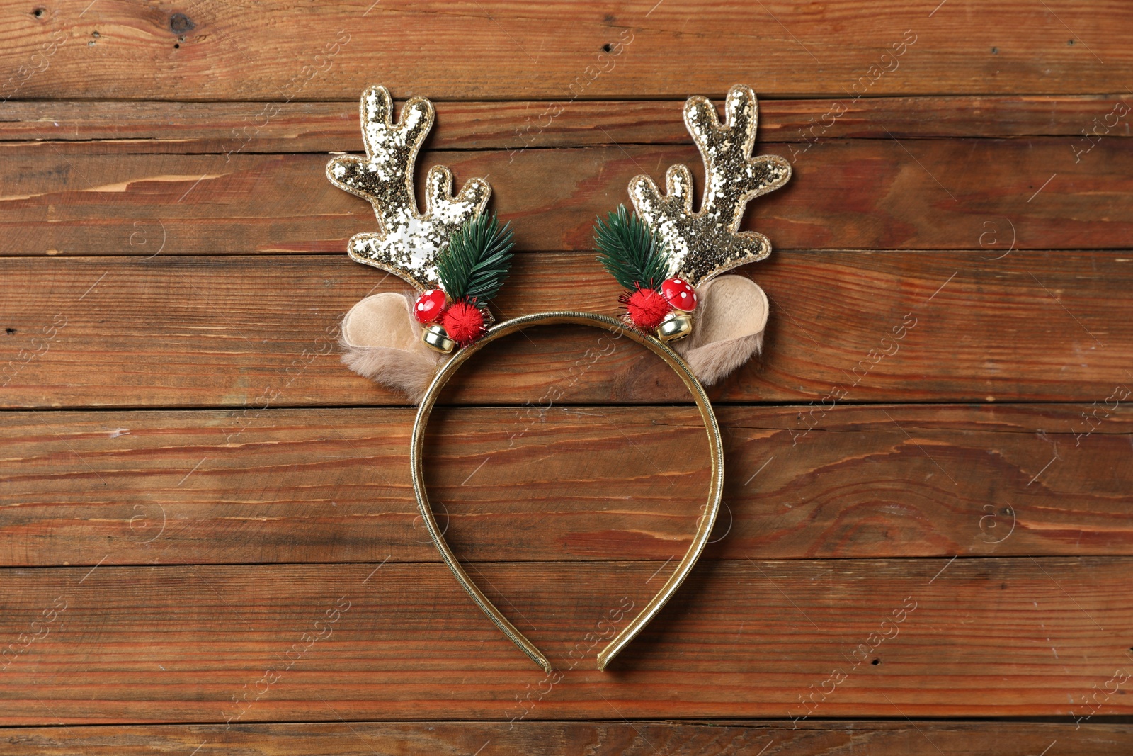 Photo of Beautiful reindeer headband on wooden background, top view. Christmas accessory