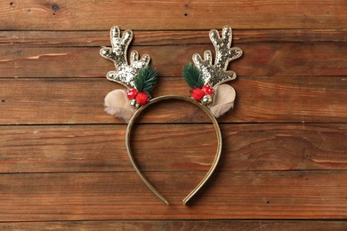 Beautiful reindeer headband on wooden background, top view. Christmas accessory