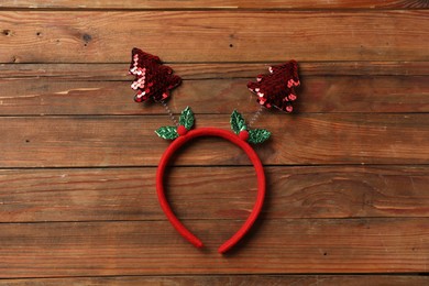 Photo of Stylish party headband on wooden background, top view. Christmas accessory