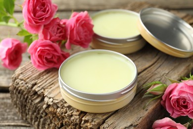 Photo of Natural solid perfume and pink roses on table, closeup