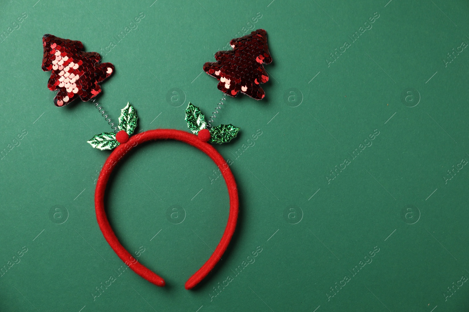 Photo of Stylish party headband on green background, top view with space for text. Christmas accessory