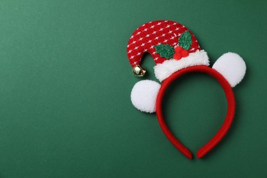 Photo of Stylish party headband on green background, top view with space for text. Christmas accessory