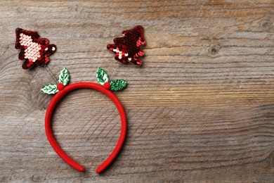 Photo of Stylish party headband on wooden background, top view with space for text. Christmas accessory