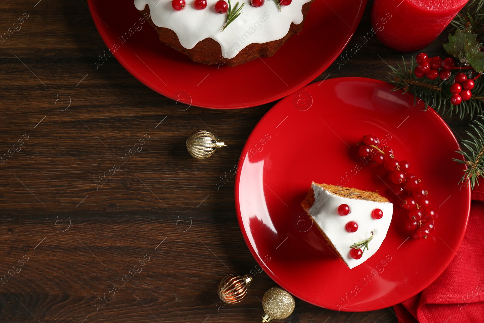 Photo of Pieces of traditional classic Christmas cake and decor on wooden table, flat lay. Space for text