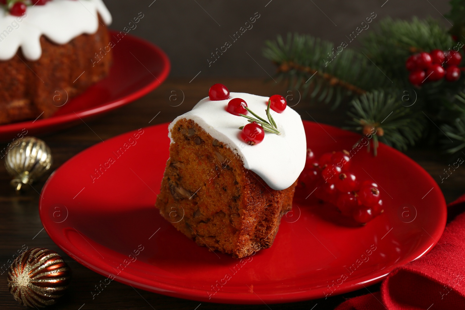 Photo of Piece of traditional classic Christmas cake and decor on wooden table, closeup