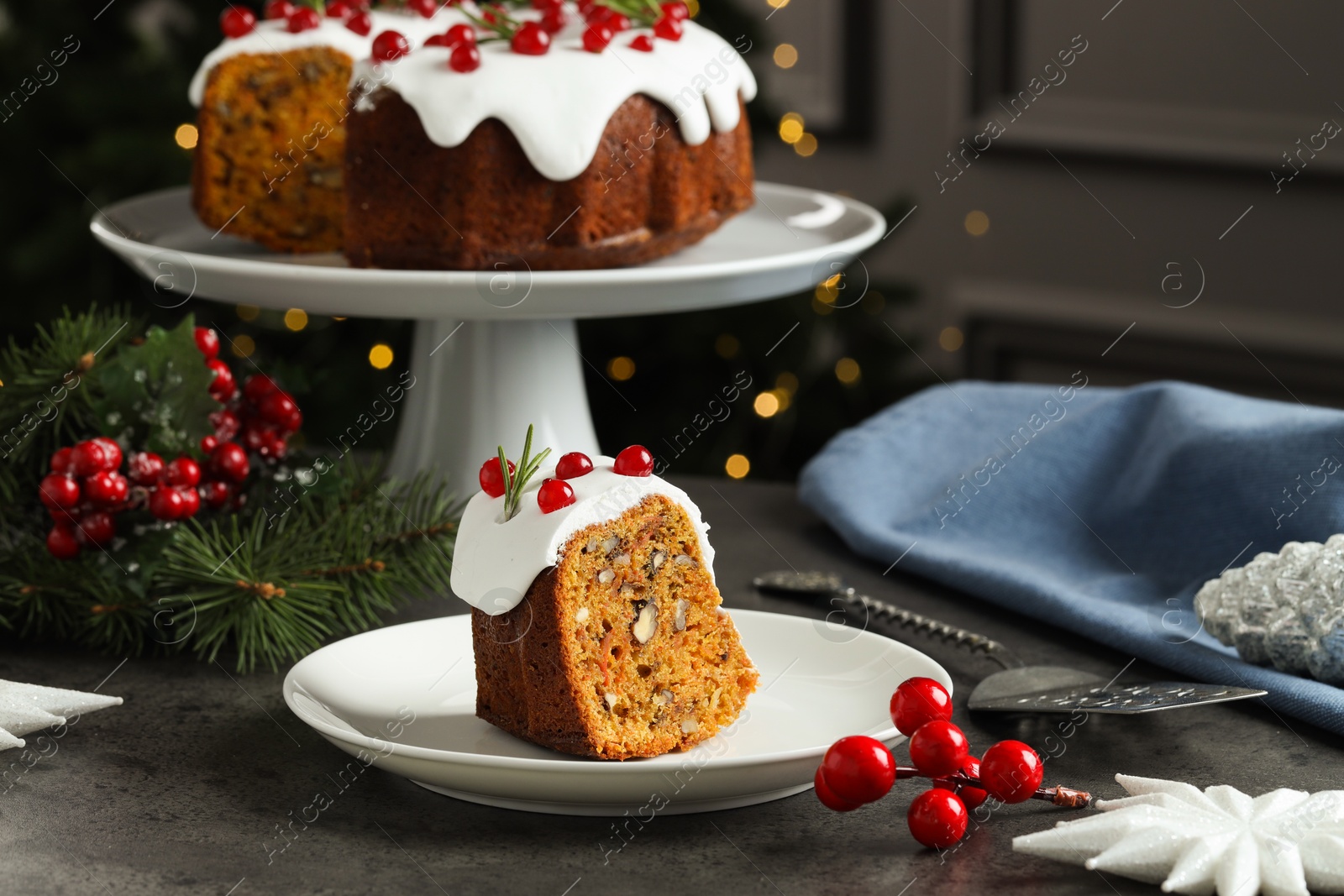 Photo of Traditional classic Christmas cake, decor and cake server on gray textured table