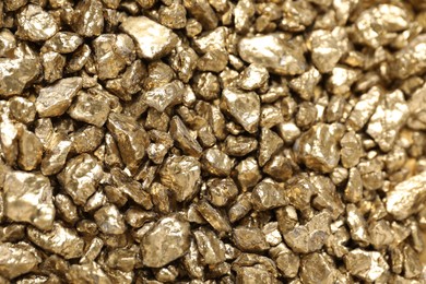 Photo of Shiny gold nuggets as background, top view