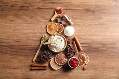 Photo of Christmas tree made with different aromatic spices on wooden table, top view