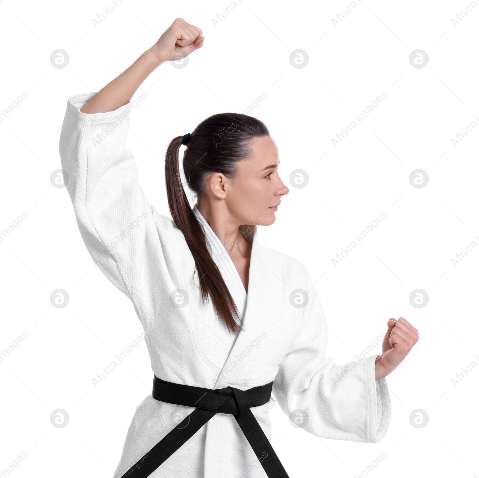 Photo of Young woman in kimono practicing karate on white background