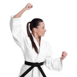 Photo of Young woman in kimono practicing karate on white background