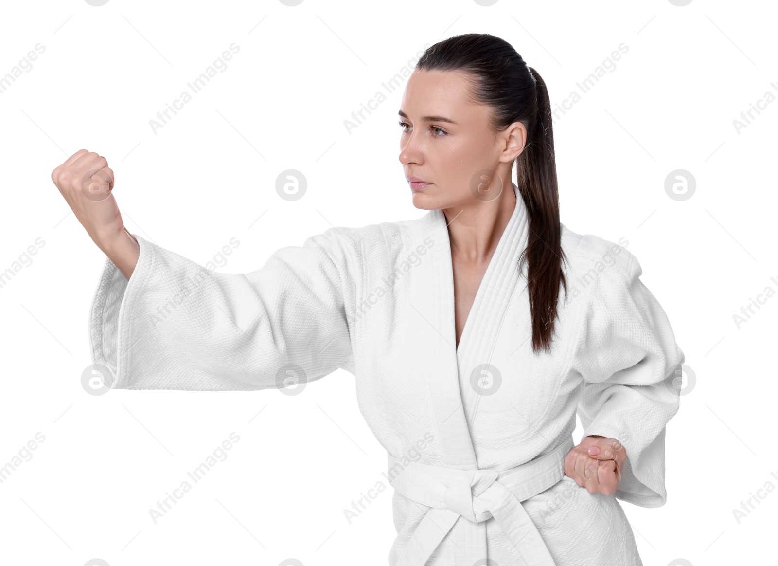 Photo of Young woman in kimono practicing karate on white background