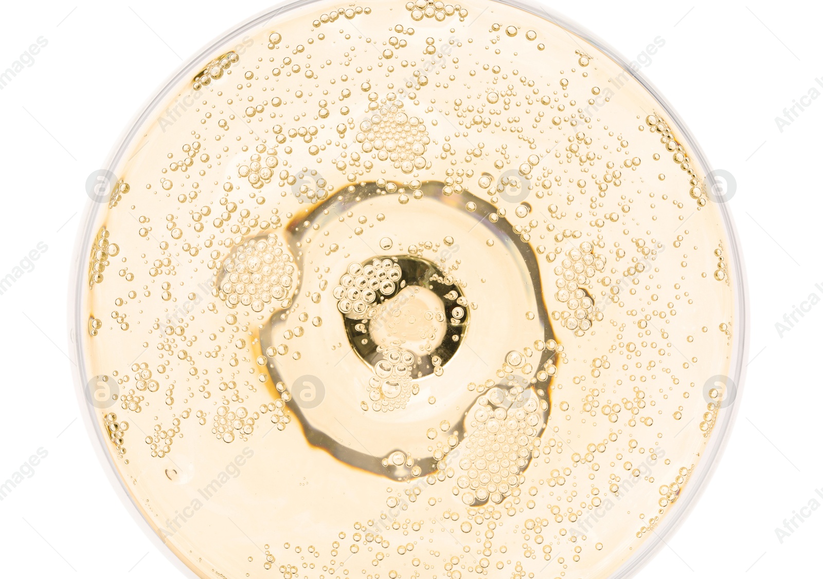 Photo of Champagne in glass isolated on white, top view