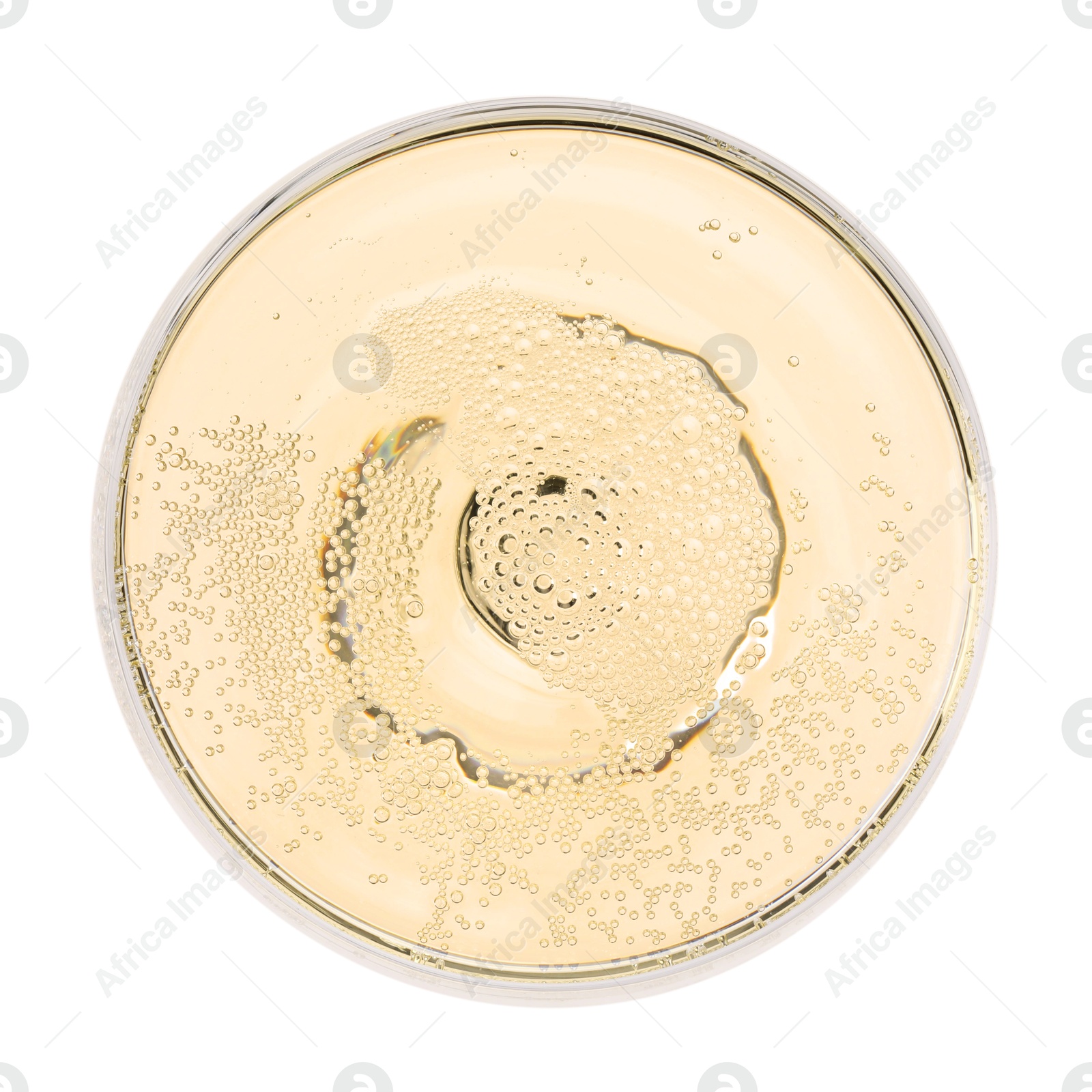 Photo of Champagne in glass isolated on white, top view