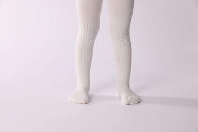 Photo of Child wearing tights on white background, closeup