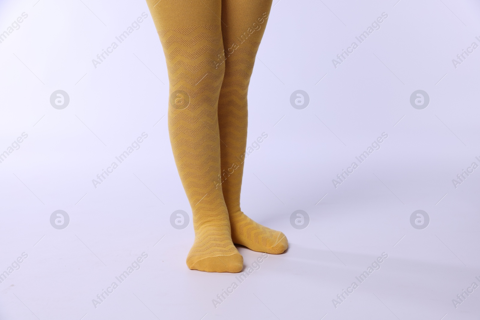 Photo of Child wearing bright tights on white background, closeup