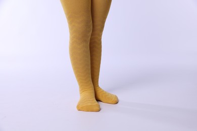 Photo of Child wearing bright tights on white background, closeup