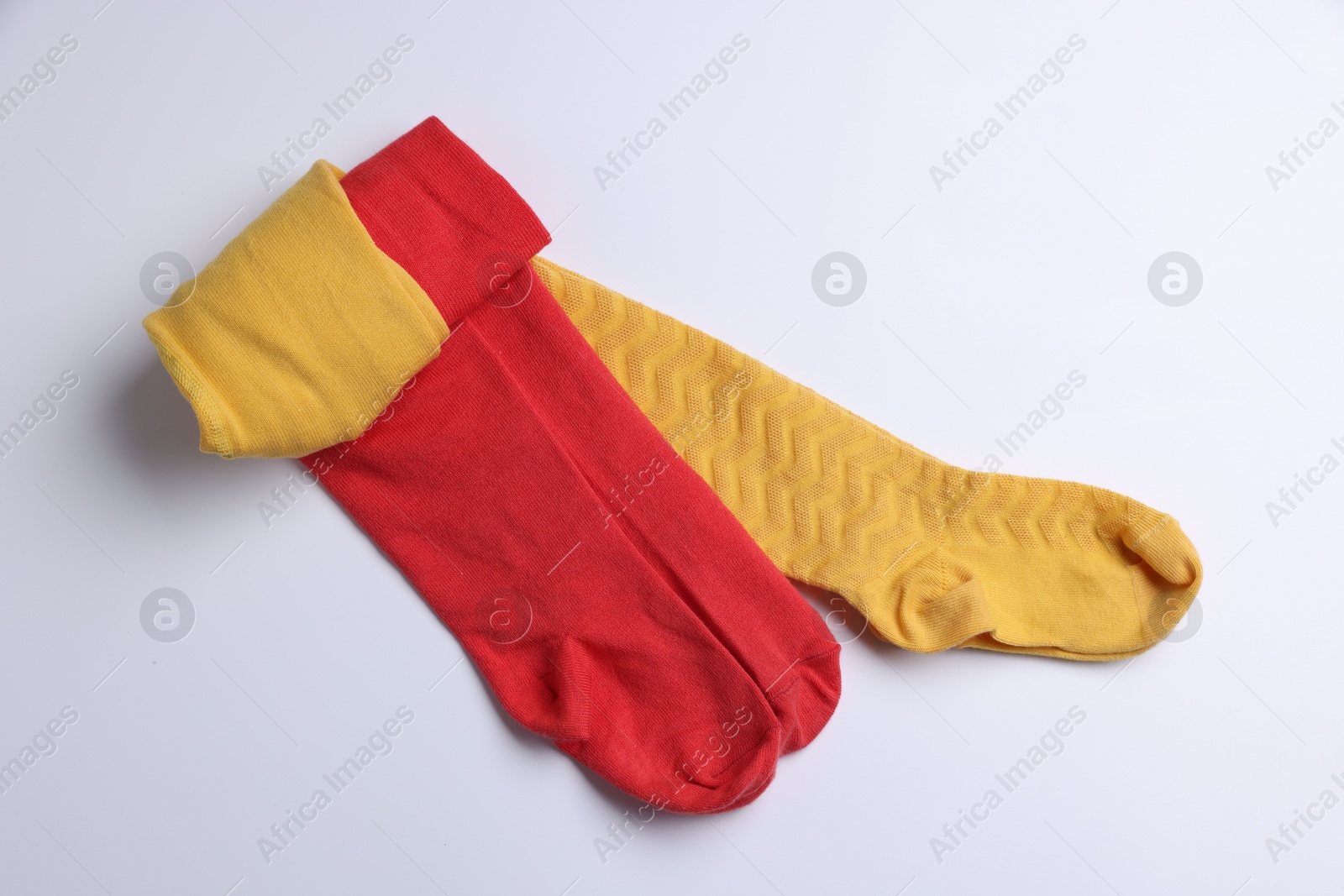 Photo of Different child's tights on white background, top view