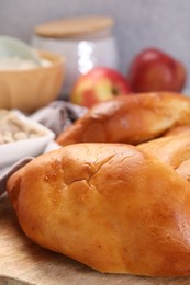 Photo of Delicious pirozhki (stuffed pastry pies) and ingredients on table, closeup