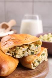 Photo of Delicious pirozhki (stuffed pastry pies) and ingredients on grey table, closeup