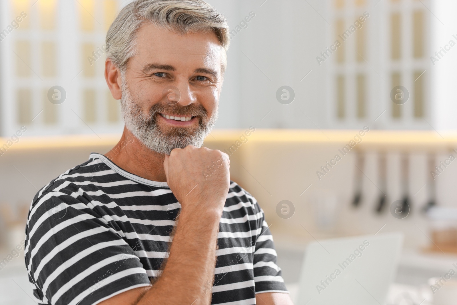 Photo of Portrait of happy middle aged man indoors, space for text