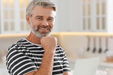 Photo of Portrait of happy middle aged man indoors, space for text