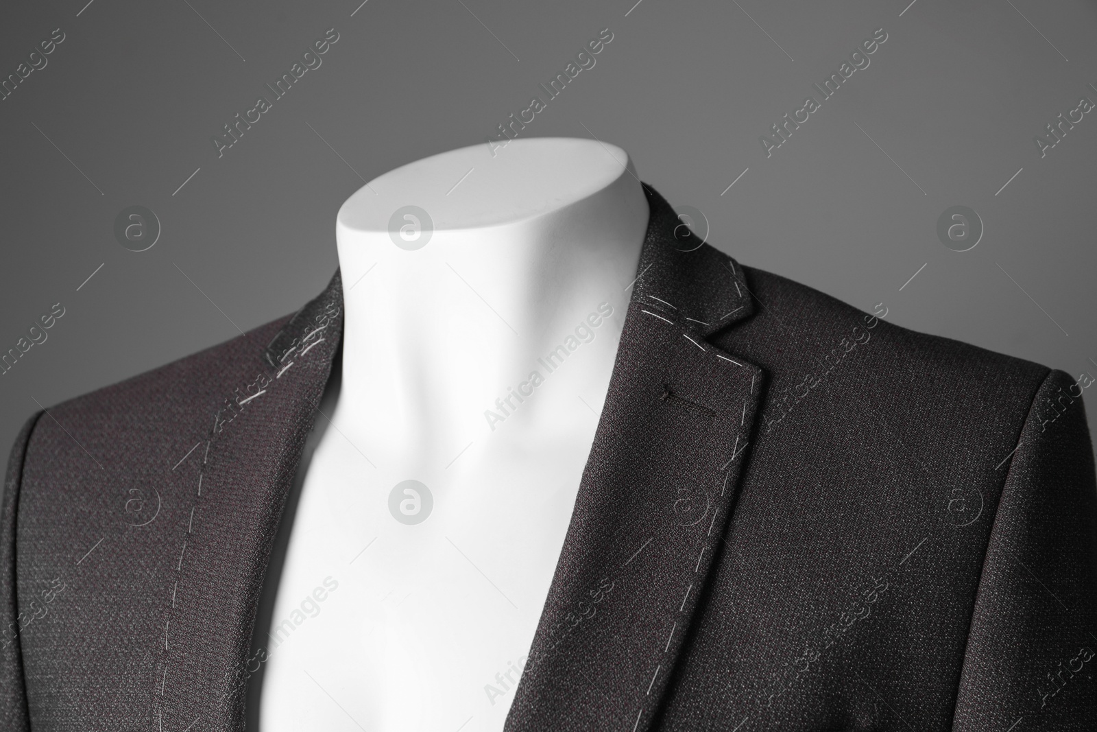 Photo of Semi-ready jacket on mannequin against grey background, closeup