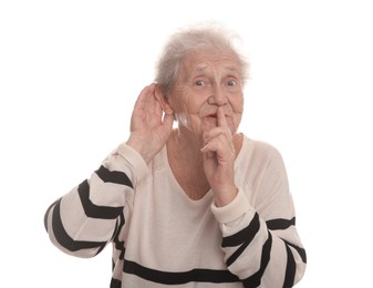 Photo of Senior woman showing hand to ear gesture on white background