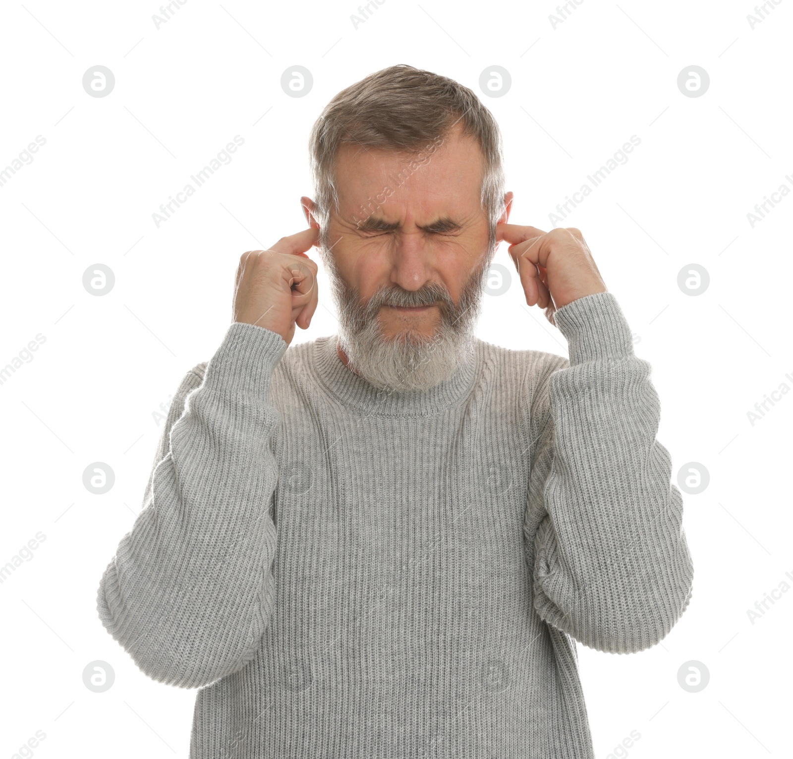 Photo of Senior man covering his ears with fingers on white background