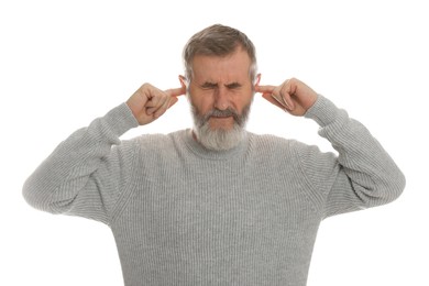 Photo of Senior man covering his ears with fingers on white background