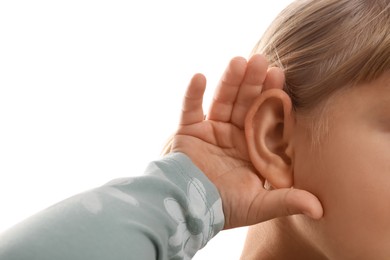 Photo of Little girl showing hand to ear gesture on white background, closeup